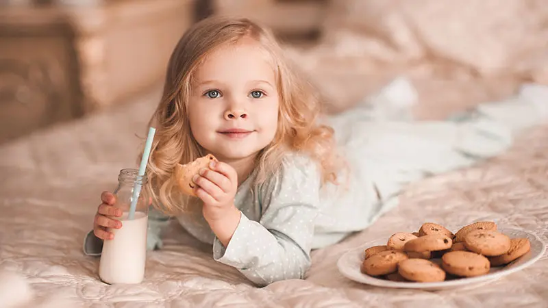 Girl with milk and cookies